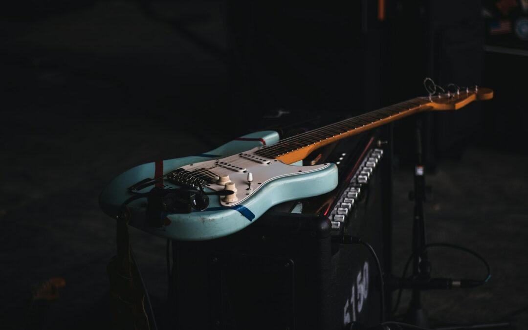 teal and brown electric guitar